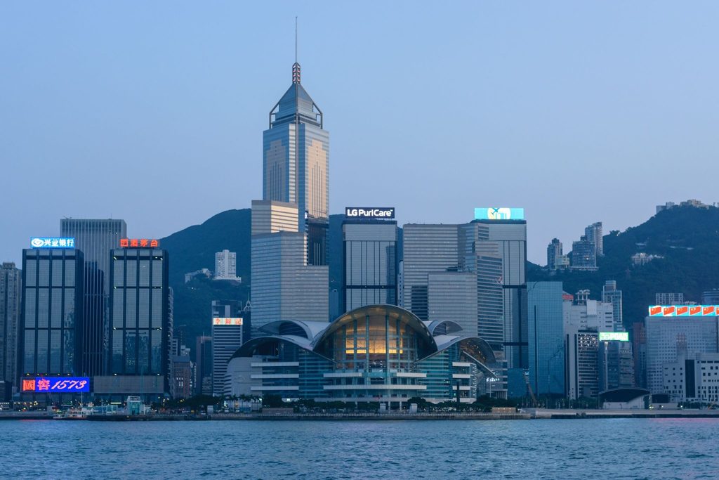 An image of the dynamic Hong Kong skyline with the iconic Convention Centre at dusk, representing the ideal location to register your Hong Kong company 100% online for a streamlined and modern business setup.