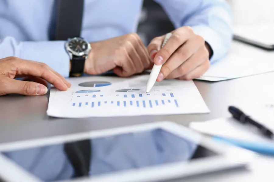 Empty cost invoice folder with a sticky note reading missing records next to an open accounting ledger
