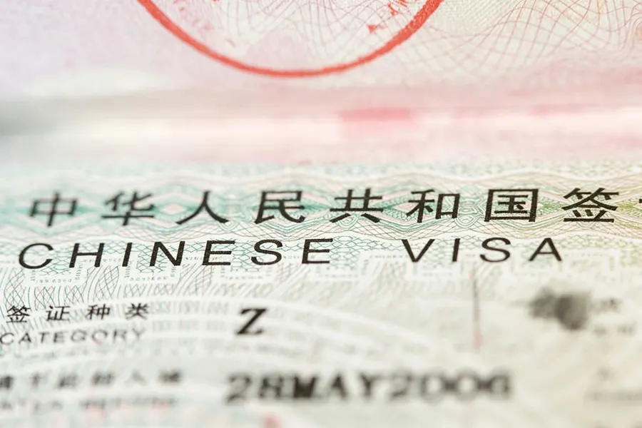 Four step flow diagram showing Z visa entry then work permit then residence permit then renewal with arrows connecting each stage