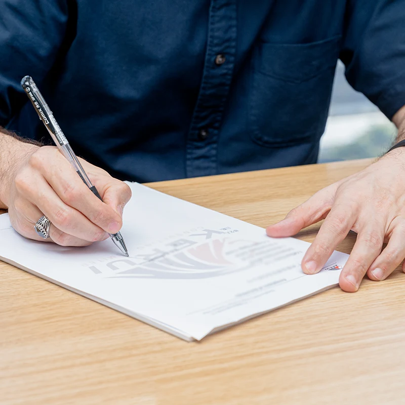 Foreign employee and employer reviewing China work visa work permit and residence permit application documents with an advisor