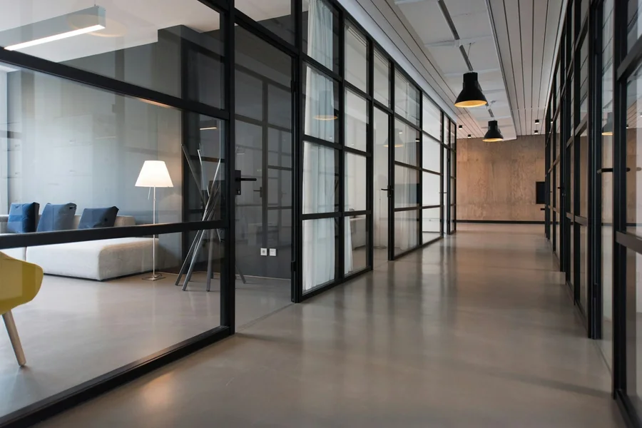 Lease agreement document beside a printed office floor plan on a desk during bank document preparation
