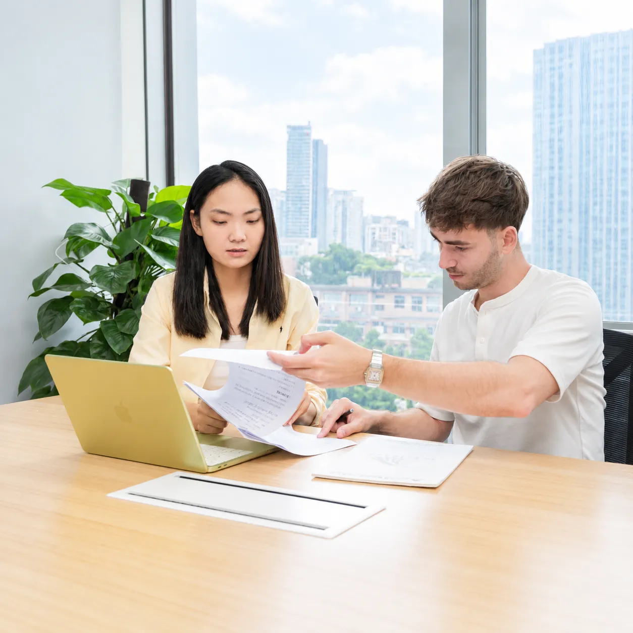 Kerui consultant and client reviewing documents together at an office desk